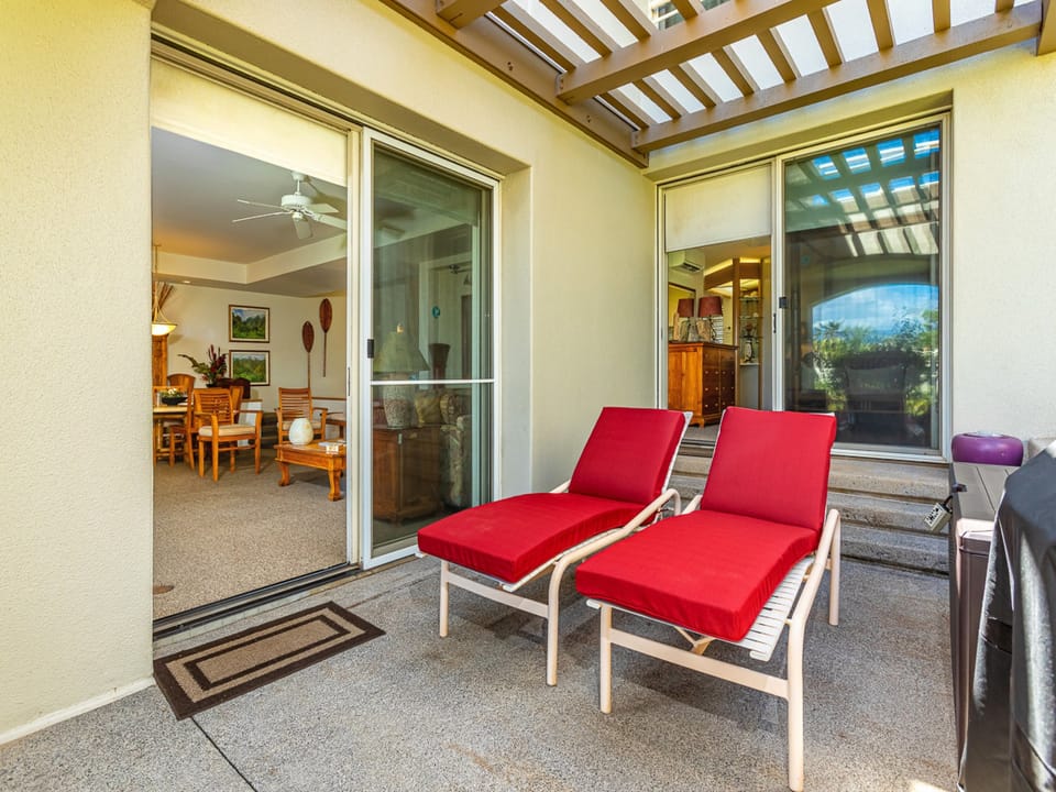 Comfortable lanai loungers near the BBQ