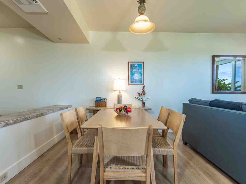 Gather around a spacious dining table where island breezes drift through the window and tropical charm sets the tone for your meals together.