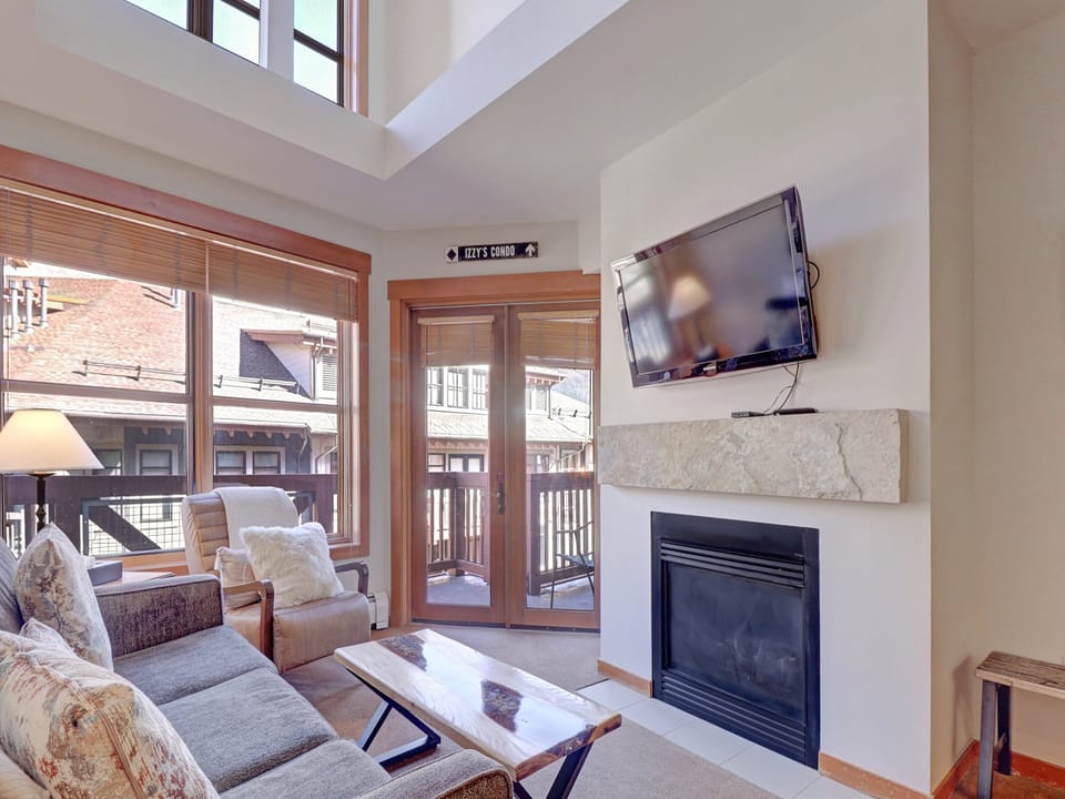 Relax in your bright, airy living space where a cozy fireplace and flat-screen TV await your mountain evenings. Step onto your private balcony to breathe in the fresh air while soaking up stunning views of the surrounding buildings and rooftops.