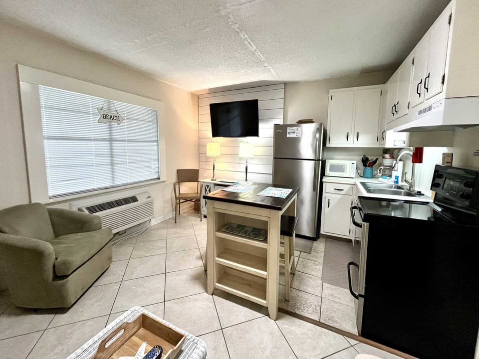 The TV next to the kitchen.dining area.