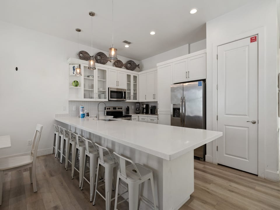 The oversized kitchen island gives everyone a place to gather, whether you're preparing breakfast or sharing evening snacks.