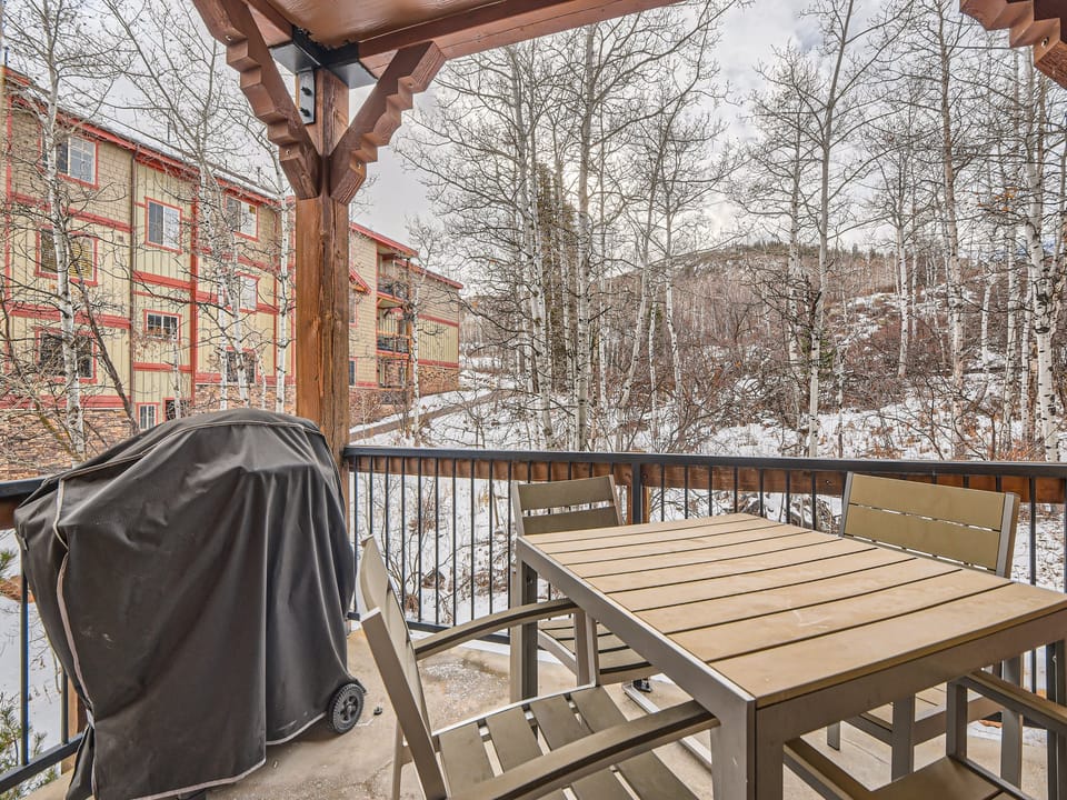 Step out onto your private balcony and breathe in the crisp mountain air surrounded by snow-dusted aspens and hillside views—a serene retreat where winter's quiet beauty is just outside your door.