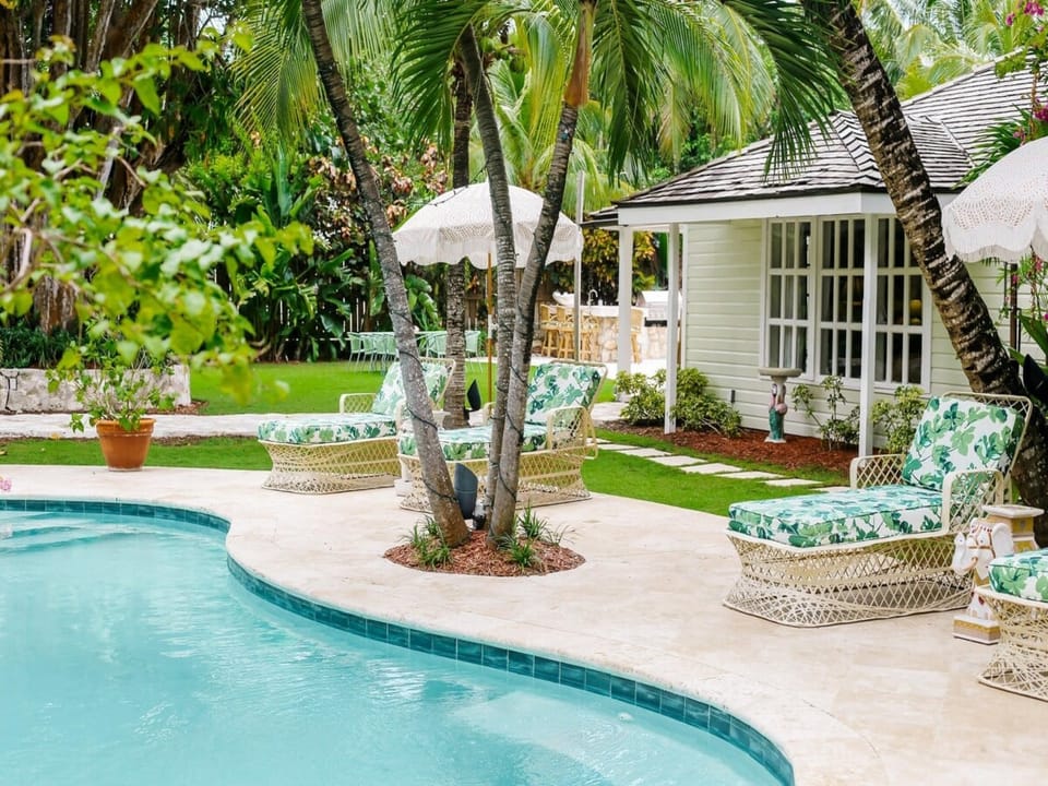 Our heated pool, equipped with pool loungers, umbrellas, pool floats, lounge seating, dining table, outdoor bar, and a sonos sound system.