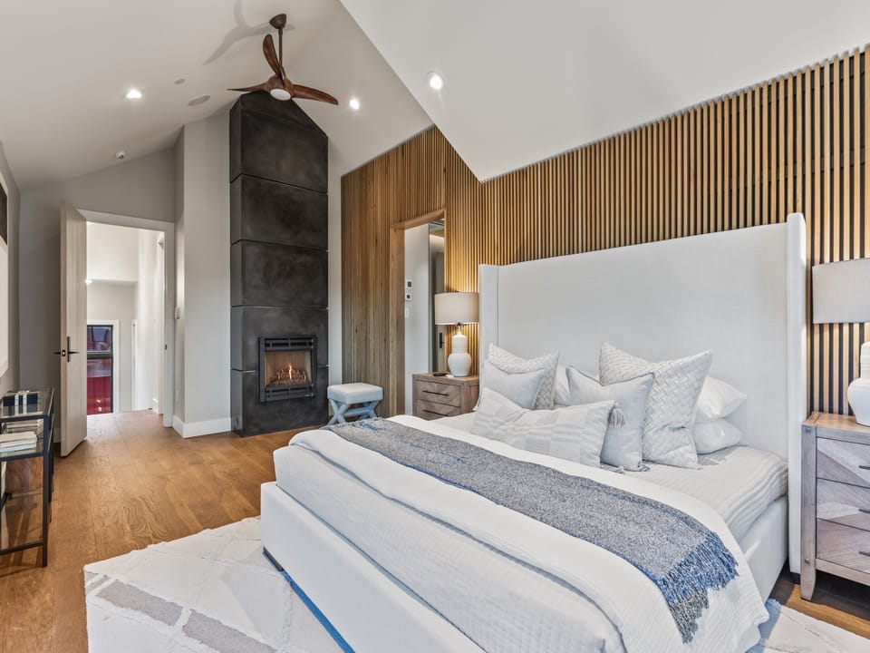 King Primary Bedroom with Ensuite, fireplace, and Smart TV