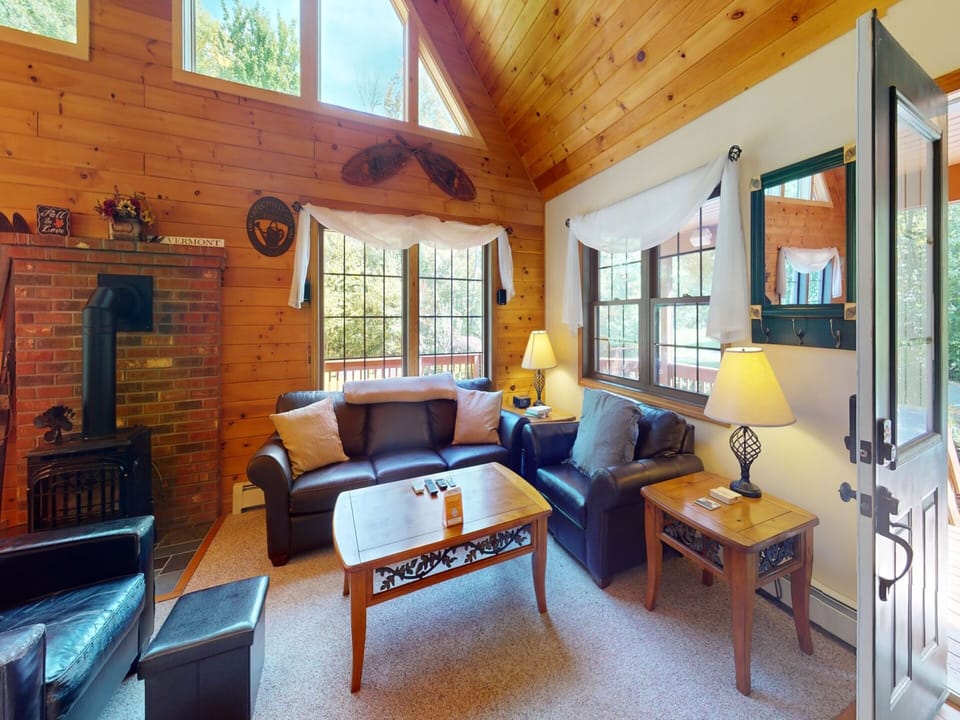 Living room with plenty of seating and natural lighting.