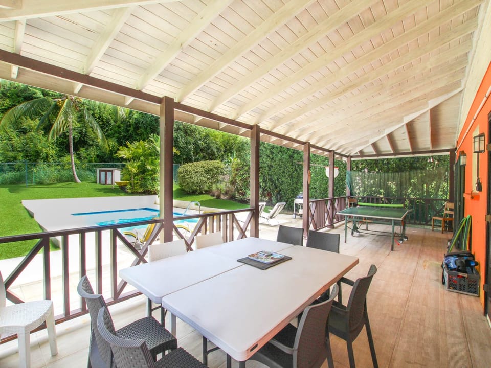 Covered verandah with outdoor dining and a table tennis table