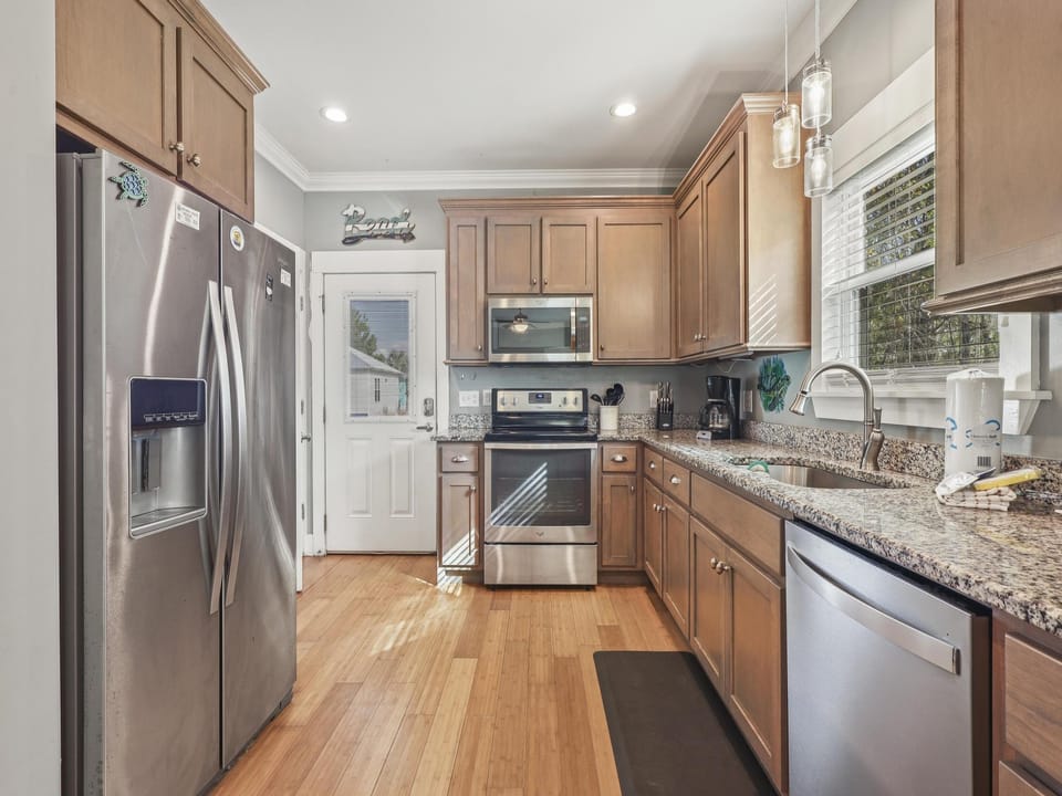 The fully stocked kitchen features stainless appliances and is fully stocked with all items needed for preparing meals during your stay.