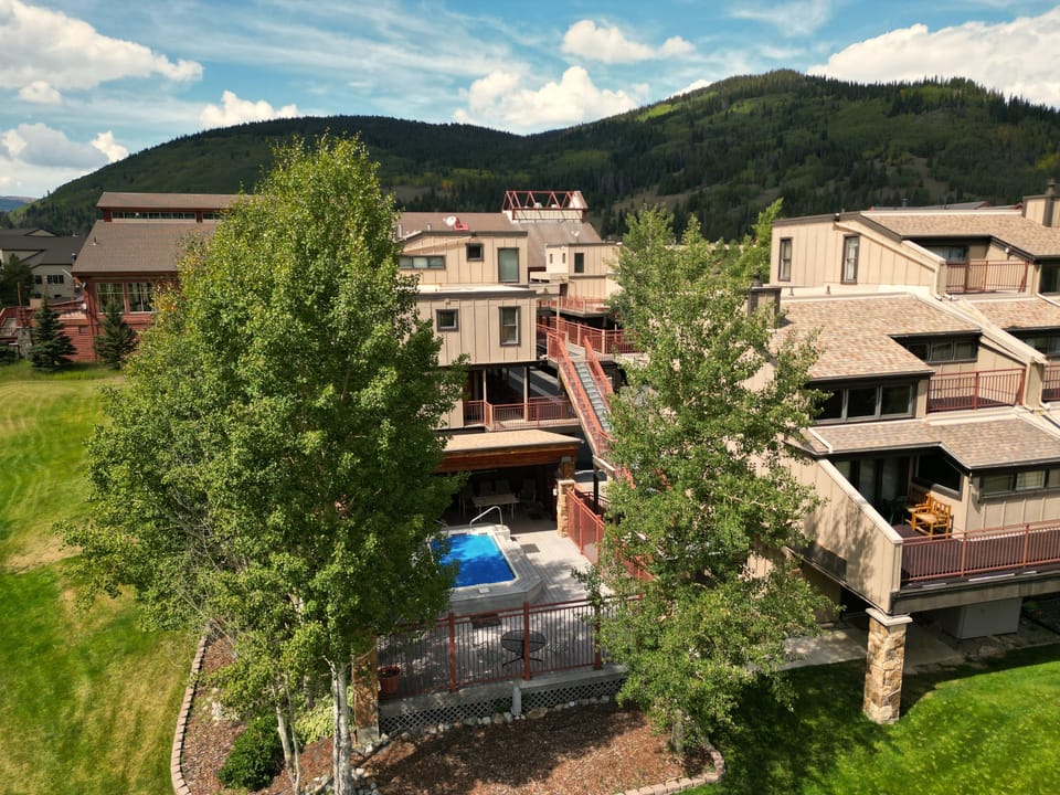 Peaking through the trees, you can see the Village Point outdoor hot tub.