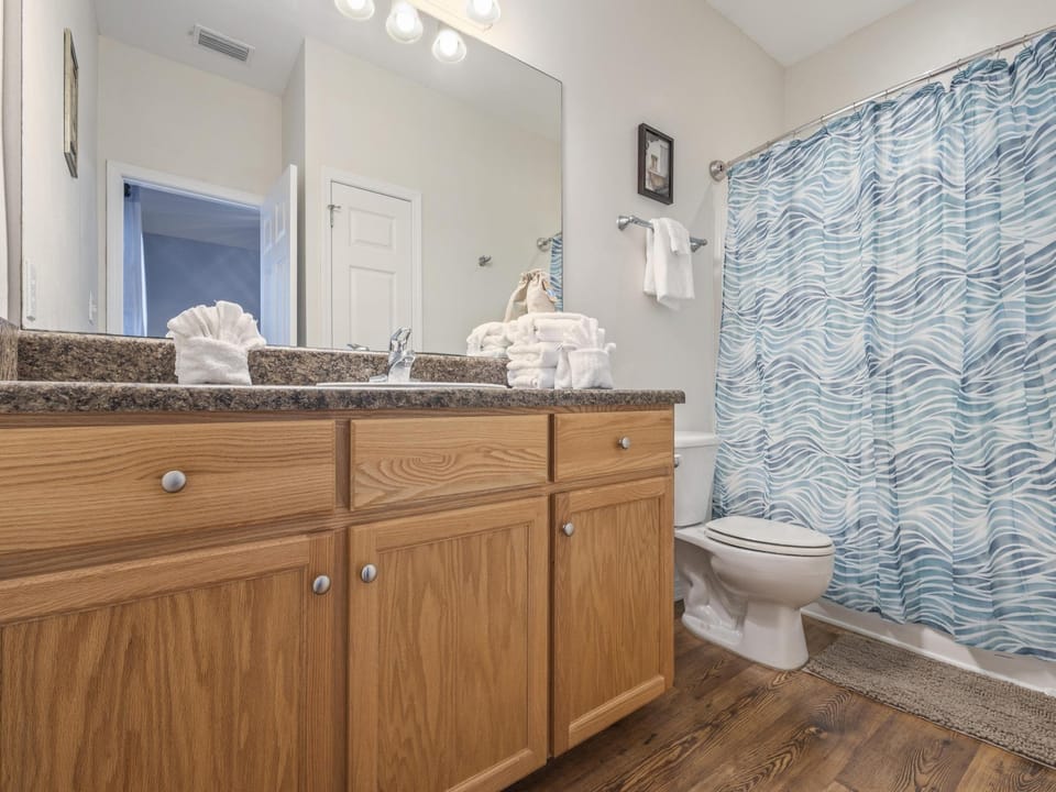 The private bathroom features a single vanity, tub/shower combo, and is fully stocked with linens for your stay.