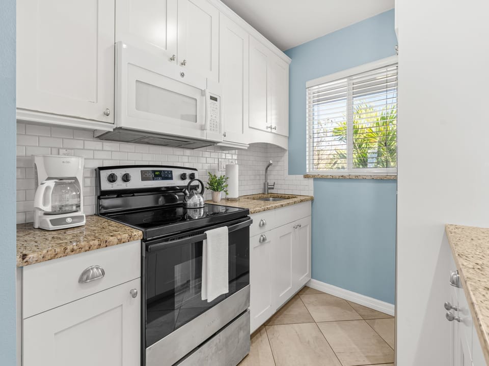 Your fully equipped kitchen features granite counters, stainless appliances, and subway tile backsplash—perfect for preparing meals in style.