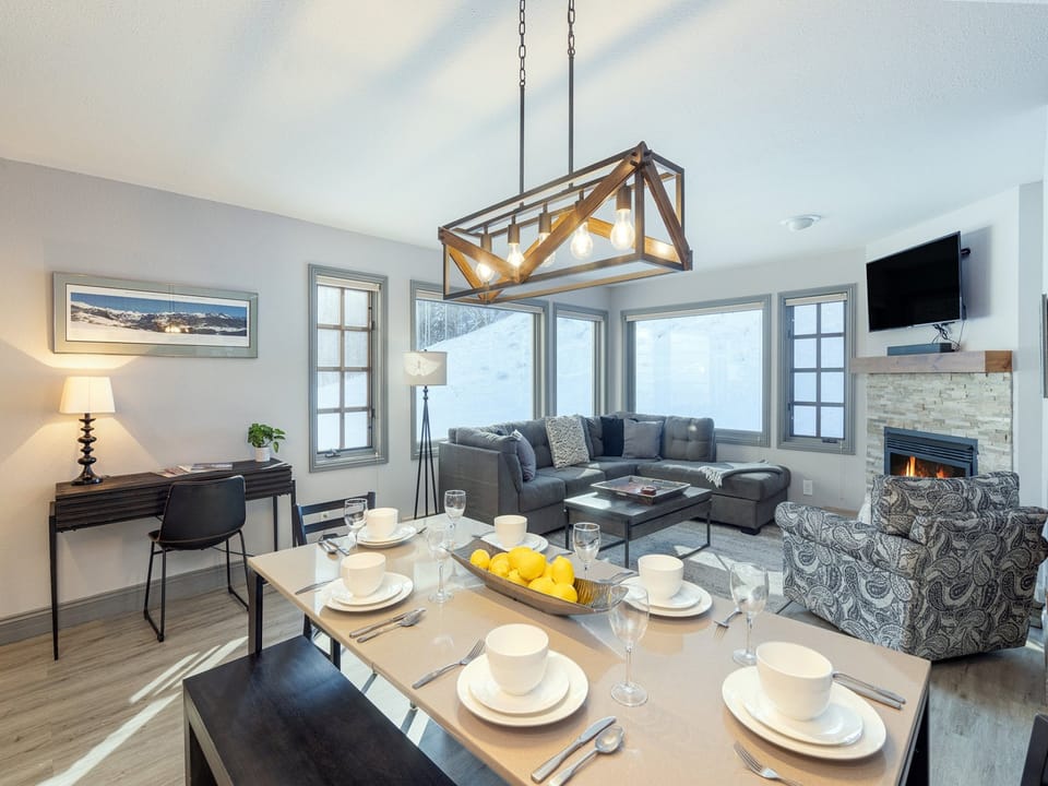 The living room of Etta Place 111 features an open plan kitchen, dining and lounge area with views of the ski run.