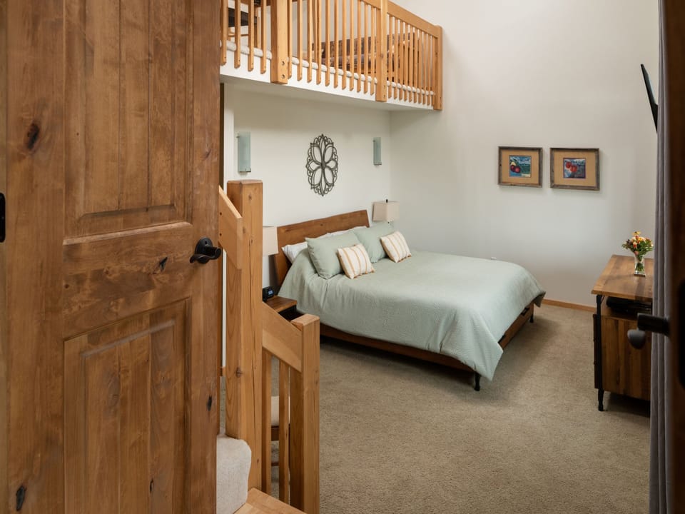 A bedroom with a bed and a bedside table.