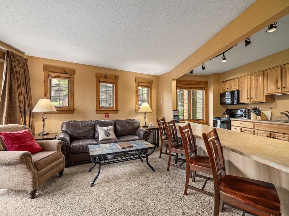 The plush living room furniture is perfect for relaxing with loved ones.  - Large couch, chair, coffee table.