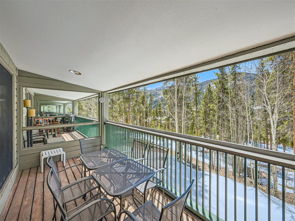 The covered deck is nestled in the trees, providing year round beauty