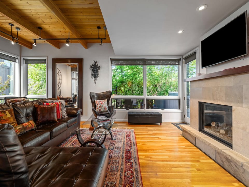 You will love watching the snow fall out of all the floor to ceiling windows on the main level.  - Windows, couch, fireplace