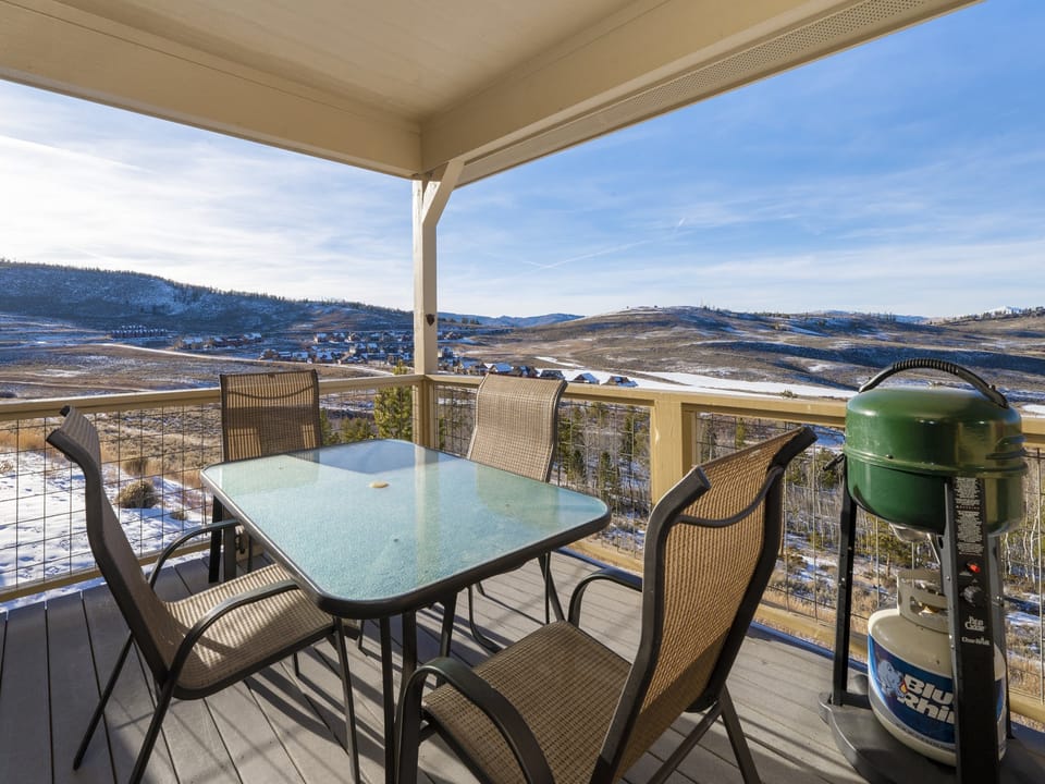 Outdoor Dining and propane gas grill on a covered deck