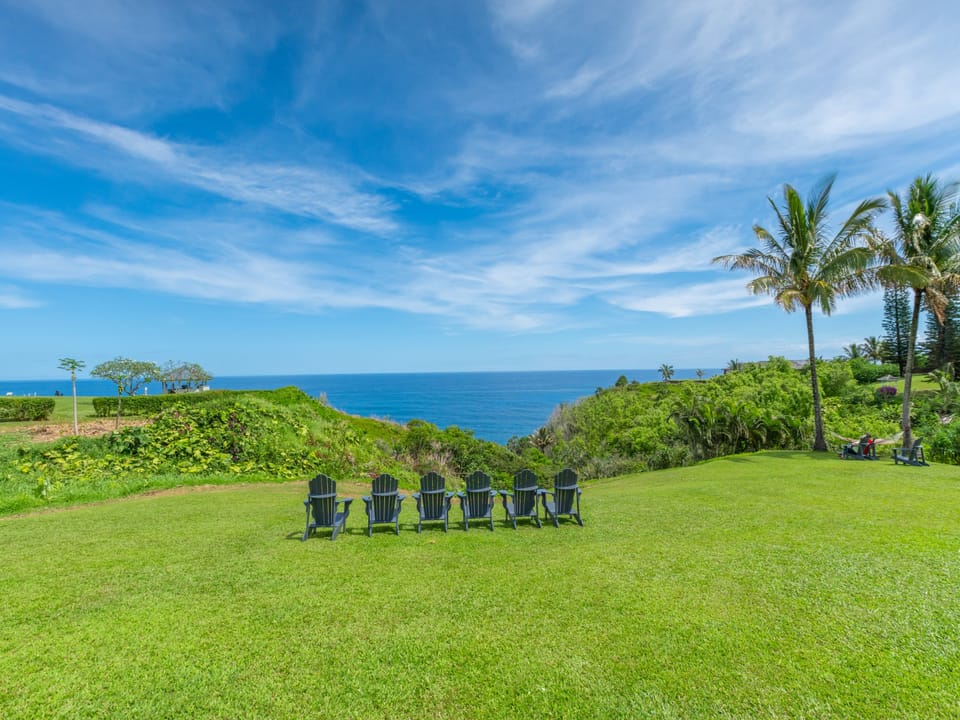 This picturesque spot offers an unobstructed panorama of the sparkling blue sea, perfect for enjoying sunrises, sunsets, or simply soaking in the serene coastal scenery.
