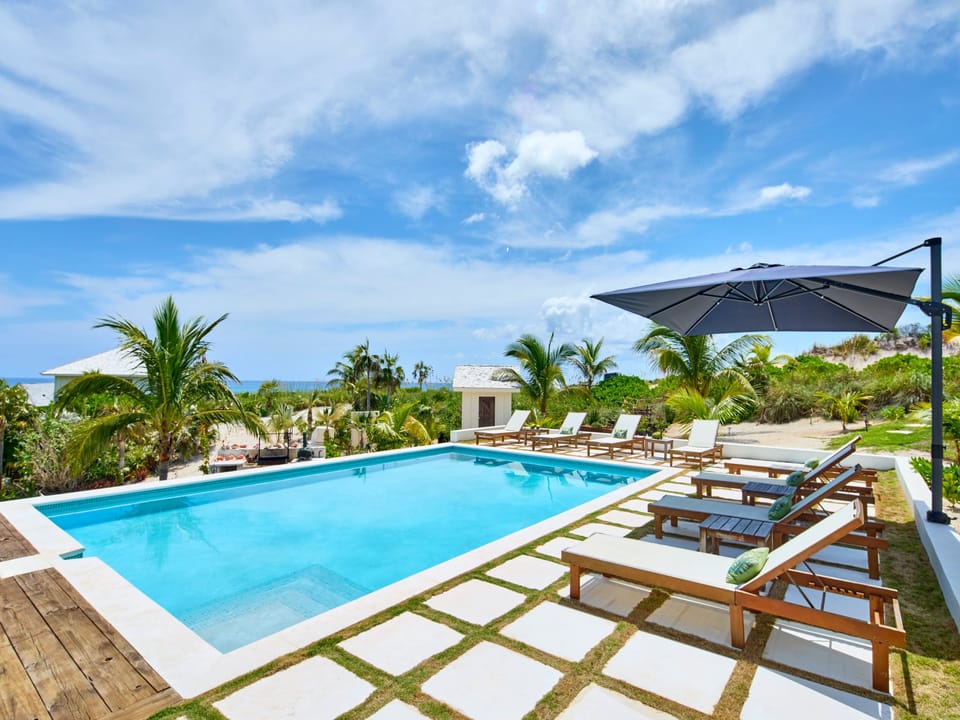 Our ocean-view heated pool sits beside our pool house, which is equipped with a lounge area, dining area, and fully stocked bar.