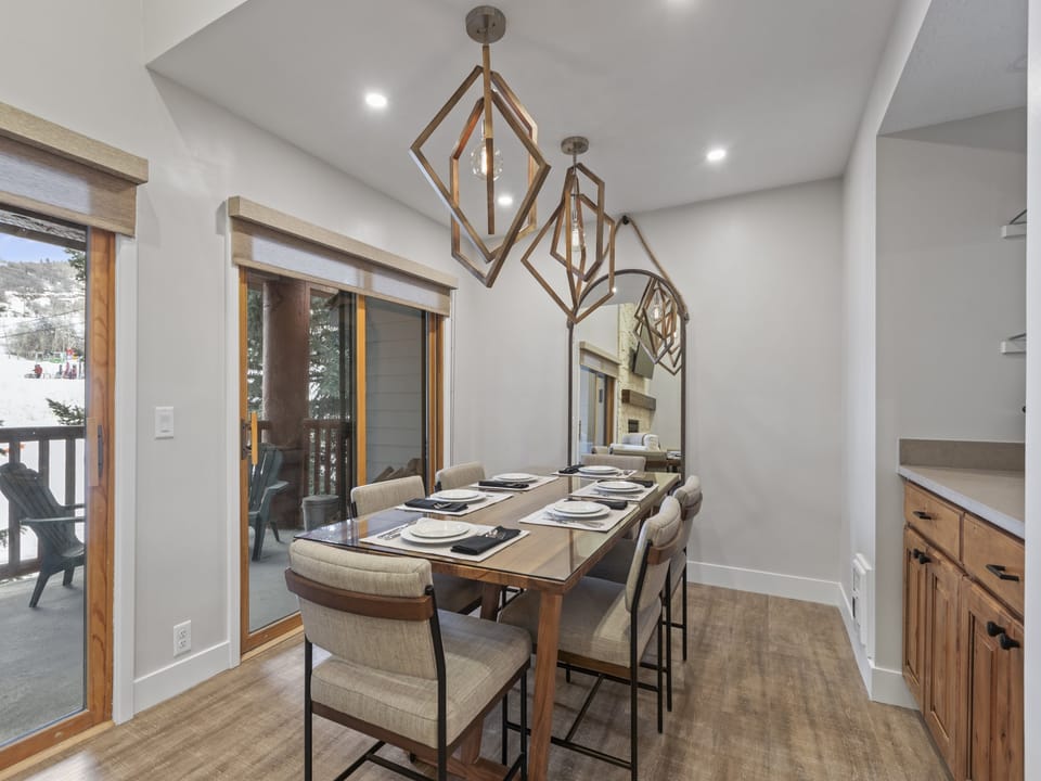 The dining area offers seating for 6 guests and has statement lighting.
