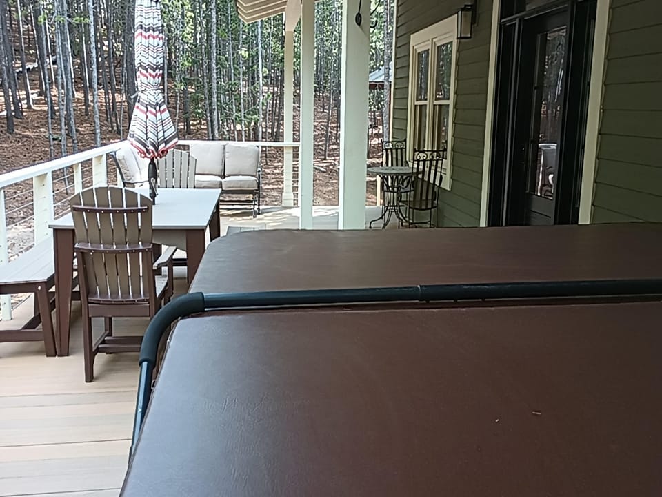 Deck with hot tub and more seating.