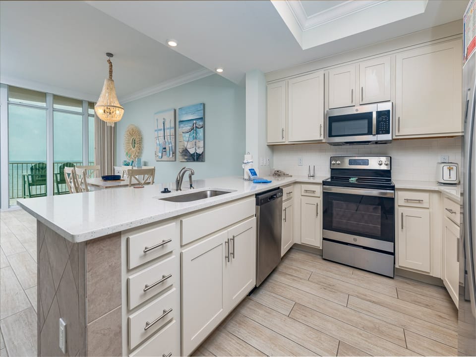 Prepare meals in this kitchen with elegant cabinetry, stainless appliances, and spacious countertops