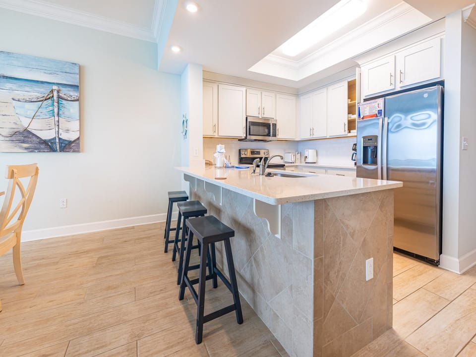 Sip your morning coffee at the breakfast bar and get ready for a beach day in this stylish space