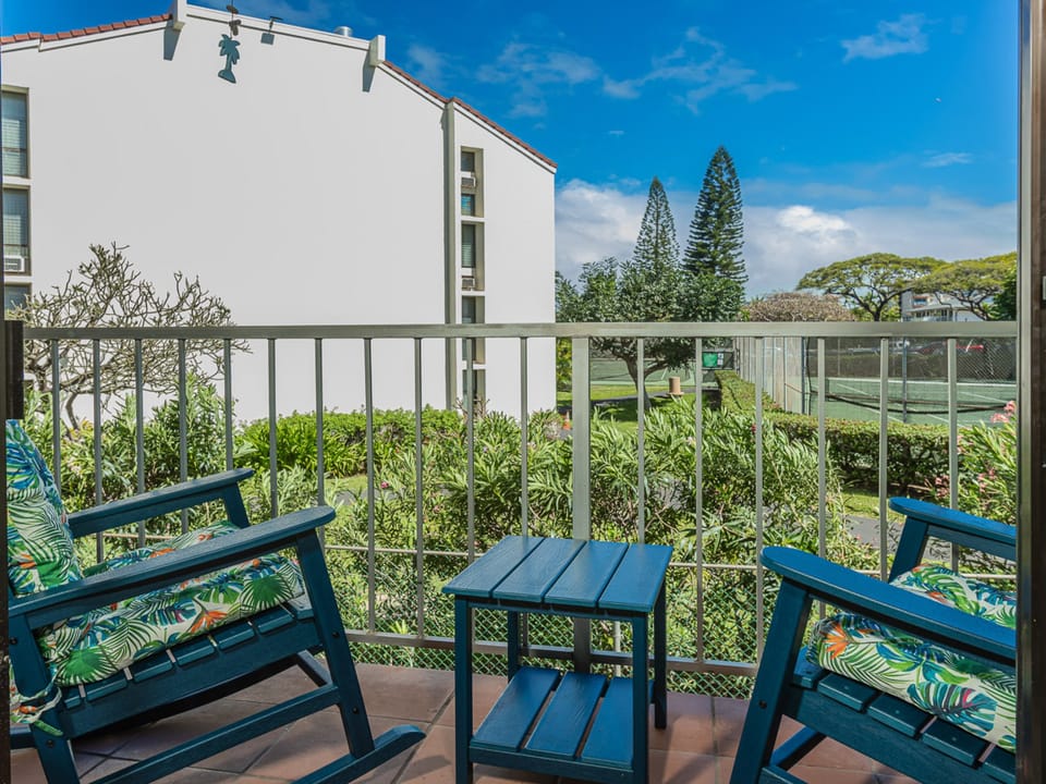Sip your morning coffee on this charming balcony, where tropical cushions and garden views create your perfect retreat.