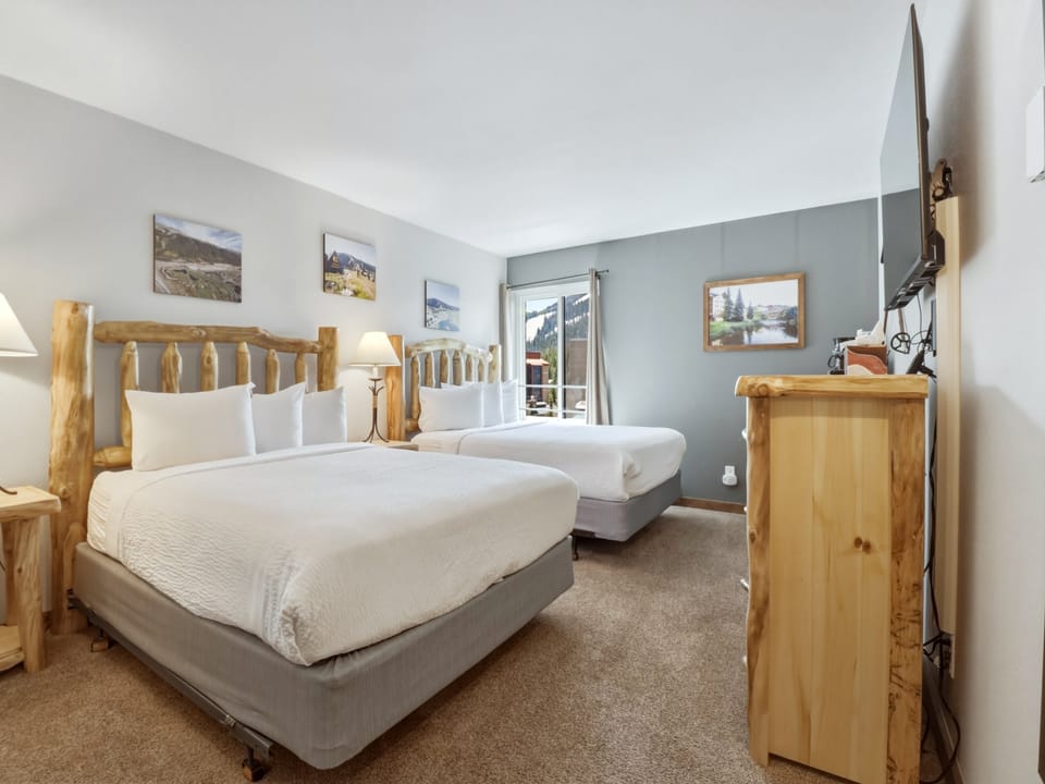 Relax in your rustic mountain retreat with handcrafted log beds, crisp linens, and peaceful views of the surrounding landscape.