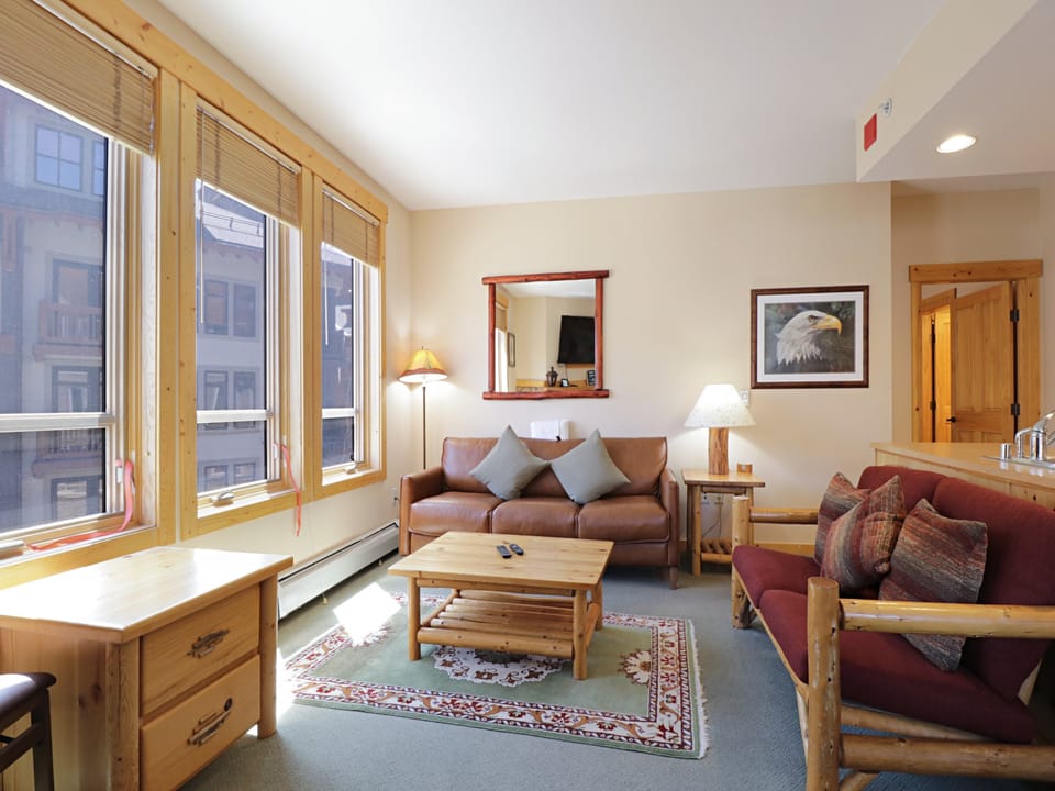 Settle into your cozy mountain retreat where warm wood furnishings and soft lighting create the perfect ambiance for relaxation after adventure.