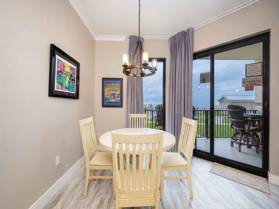 Gather around the round table in this inviting kitchen, featuring sleek appliances and warm lighting for a cozy atmosphere