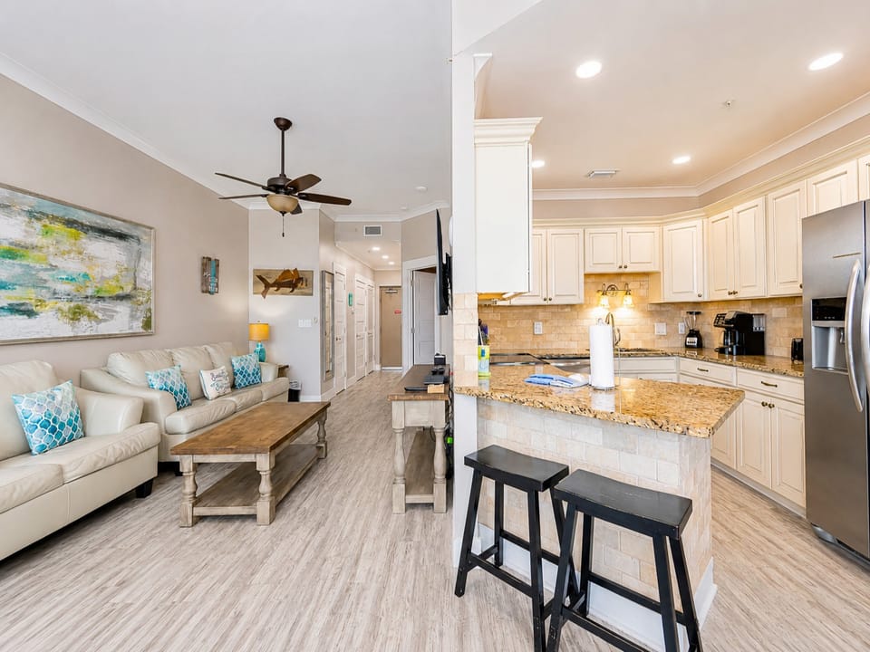 Enjoy meals at the round dining table surrounded by colorful artwork and natural light from the sliding doors