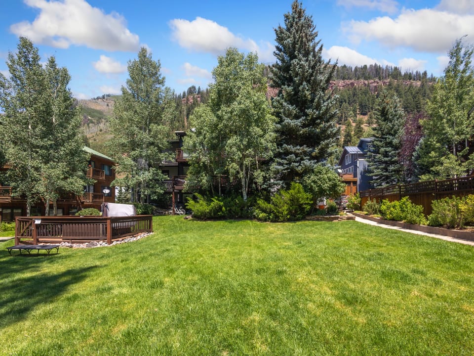 Tomboy Lodge communal grassy with shared hot tub.