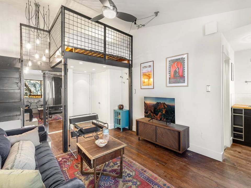 Spacious studio apartment with queen bed, cozy couch, tv, storage for gear and galley kitchen.