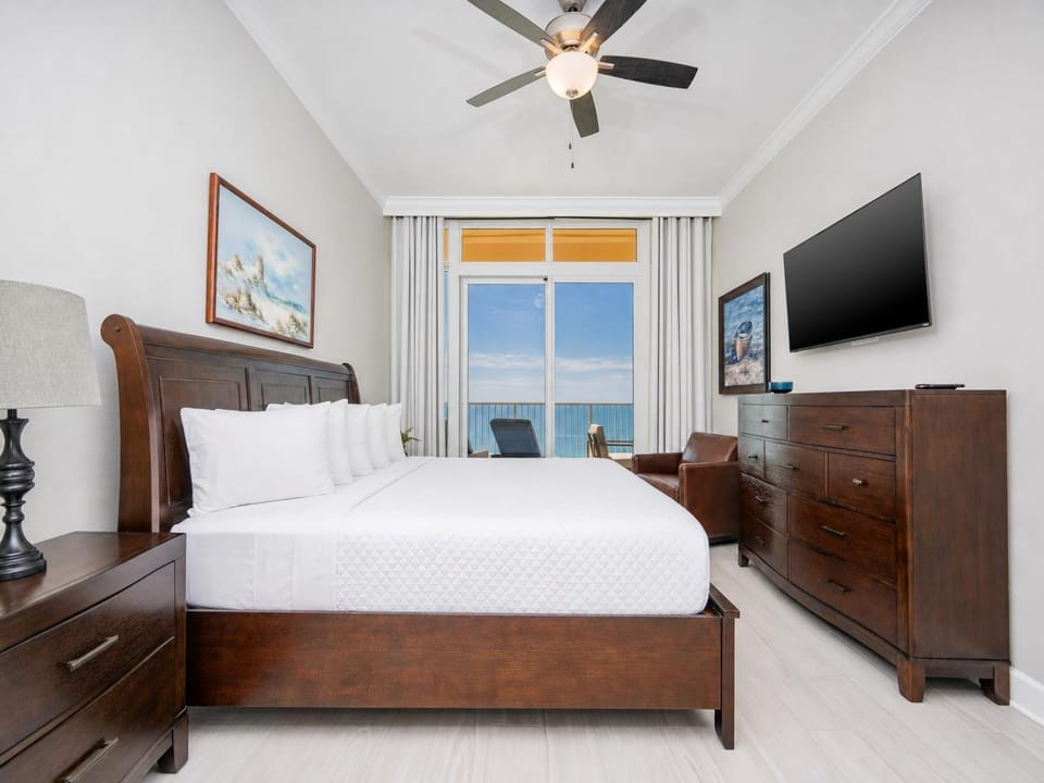 Retreat to the king master suite with cozy bedding and drift off to the sound of the waves from the balcony