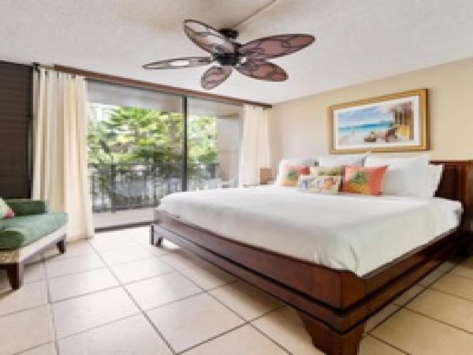 Step into your serene retreat where crisp white linens invite restful sleep, tropical breezes flow from your private balcony, and warm tile floors ground this peaceful island escape.