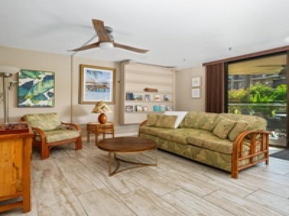 Step into your private retreat where island charm meets modern comfort. Sink into the woven rattan sofa, feel the tropical breeze from the ceiling fan, and enjoy garden views through large windows.