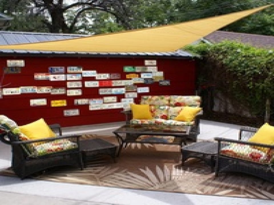 Private patio with comfy seating, and shade overhead—perfect for morning coffee or evening relaxation.