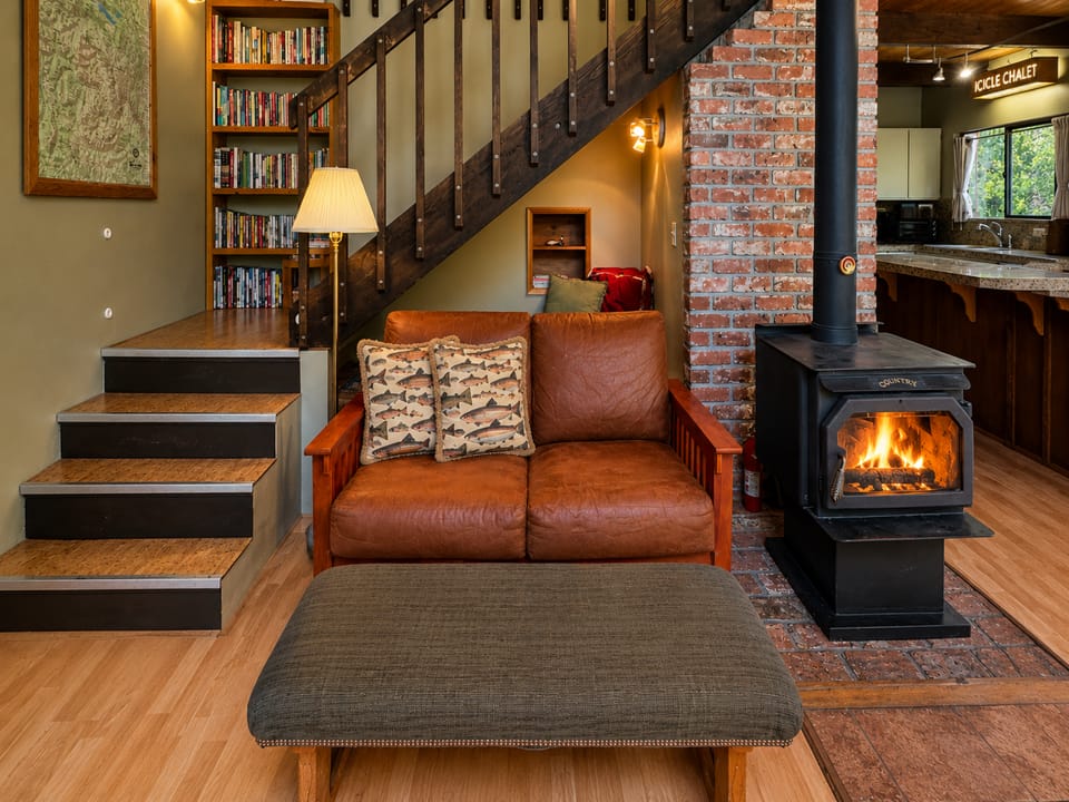 Living Area features picture windows that showcase the beautiful outdoor views, streaming TV and cozy wood fireplace.