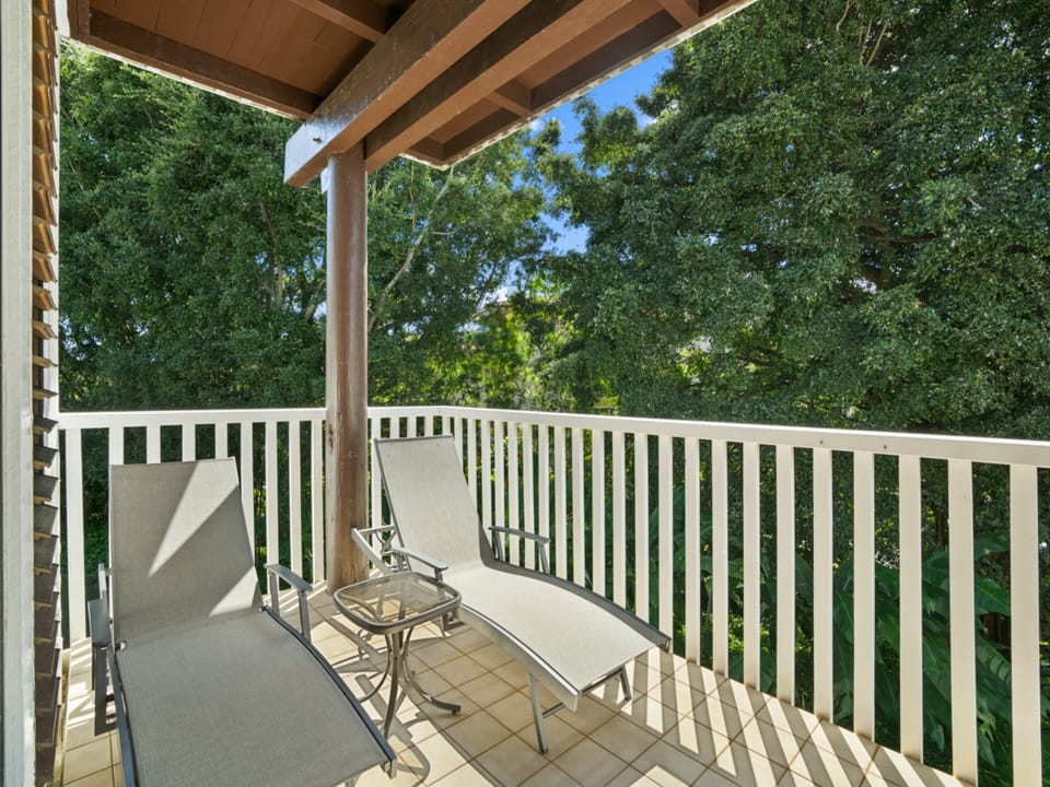 Step onto your private balcony to unwind with treetop views and fresh air, where a lounge chair awaits your morning coffee or afternoon relaxation.