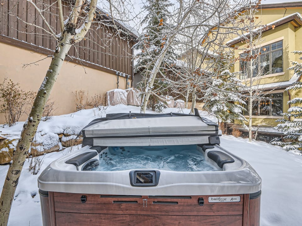 Soak your cares away in the bubbling hot tub, nestled under mature aspens in a tranquil, sun-dappled backyard oasis.