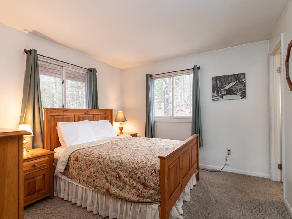 Relax in the primary bedroom featuring a cozy queen bed for a restful night's sleep.