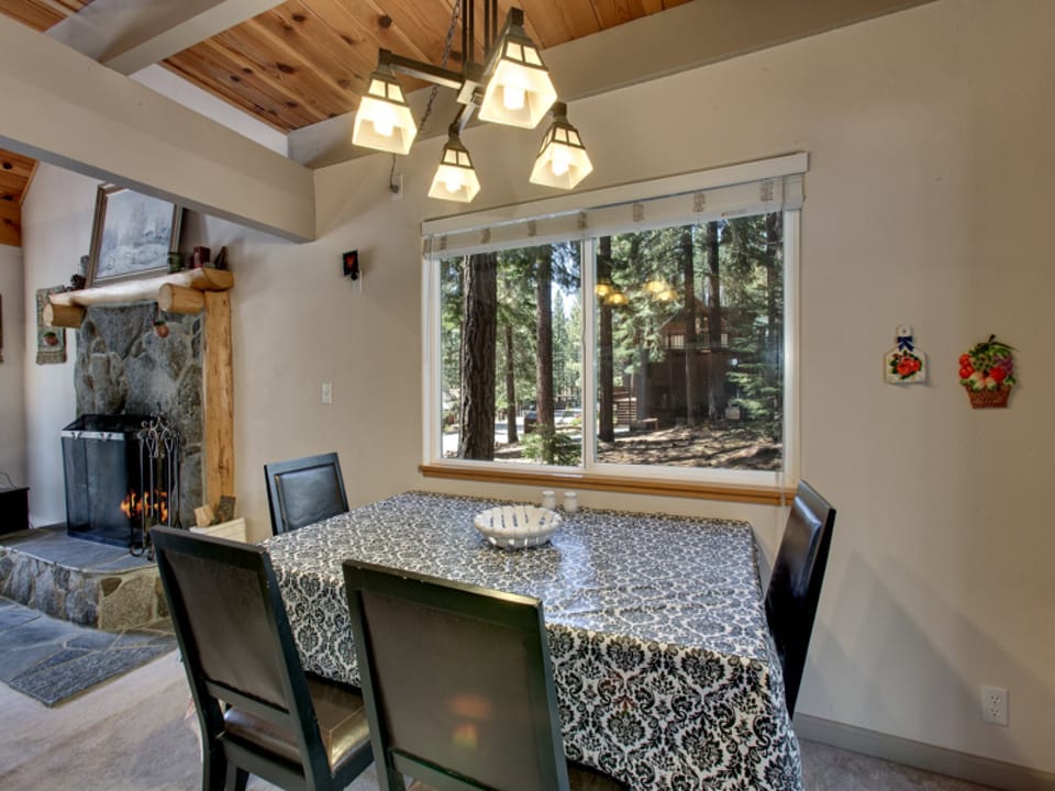 Dining area with a forest view, perfect for enjoying meals with family and friends.