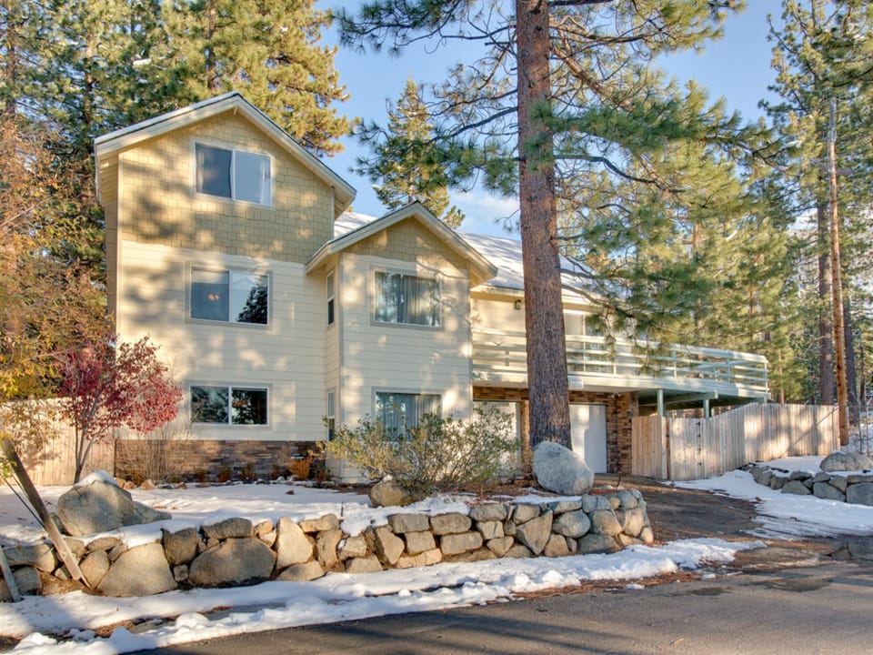 Welcome to your mountain retreat! A charming multi-story chalet nestled among tall pines.