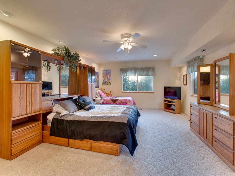 Spacious primary bedroom with a king bed, natural light, and plenty of storage for a comfortable stay.