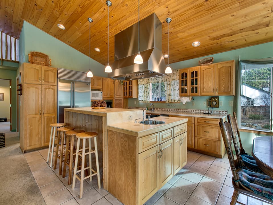 A spacious kitchen with modern appliances, a large island, and warm wood finishes—perfect for cooking and gathering.
