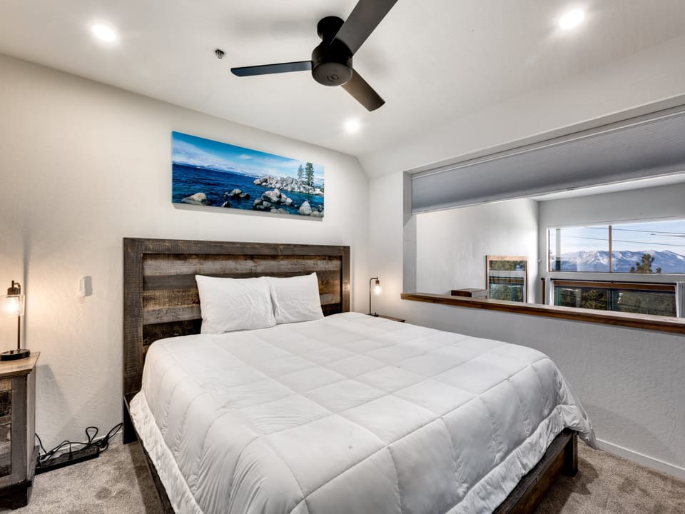Bright and modern bedroom with a king-size bed and scenic window views.