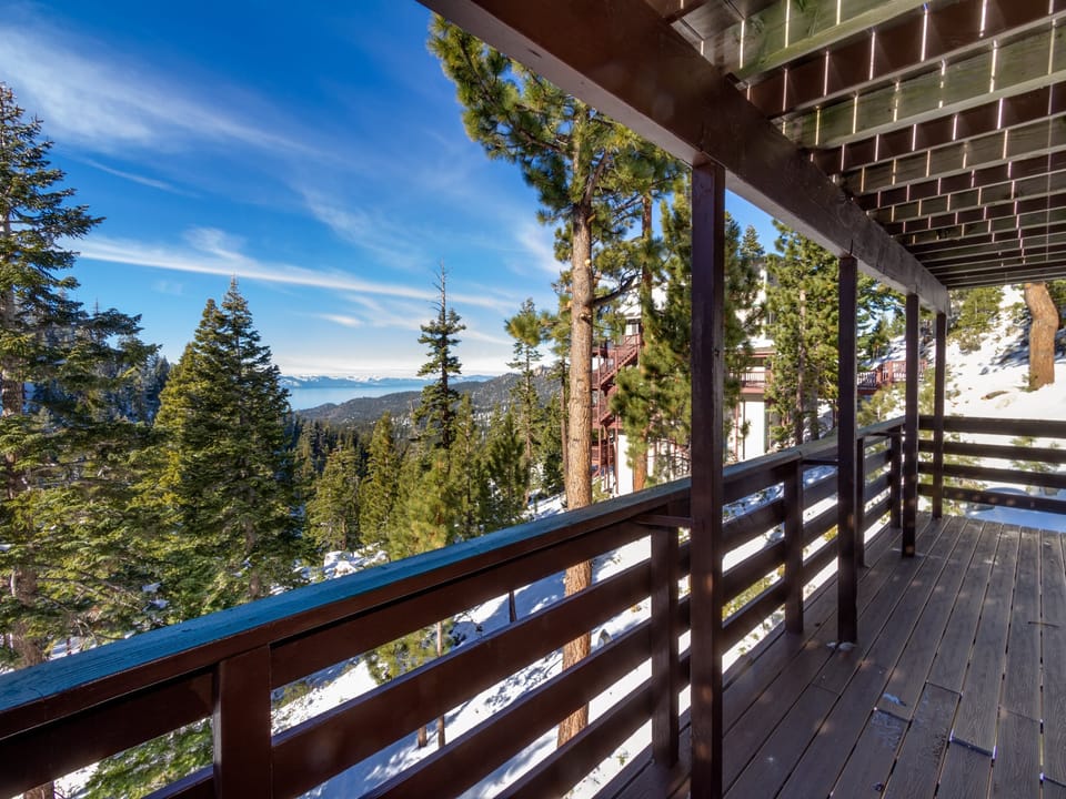 Expansive deck offering stunning mountain and forest views, ideal for morning coffee.