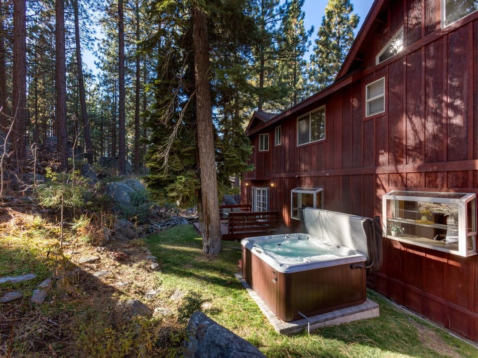 Step outside and soak in the private hot tub under the trees.