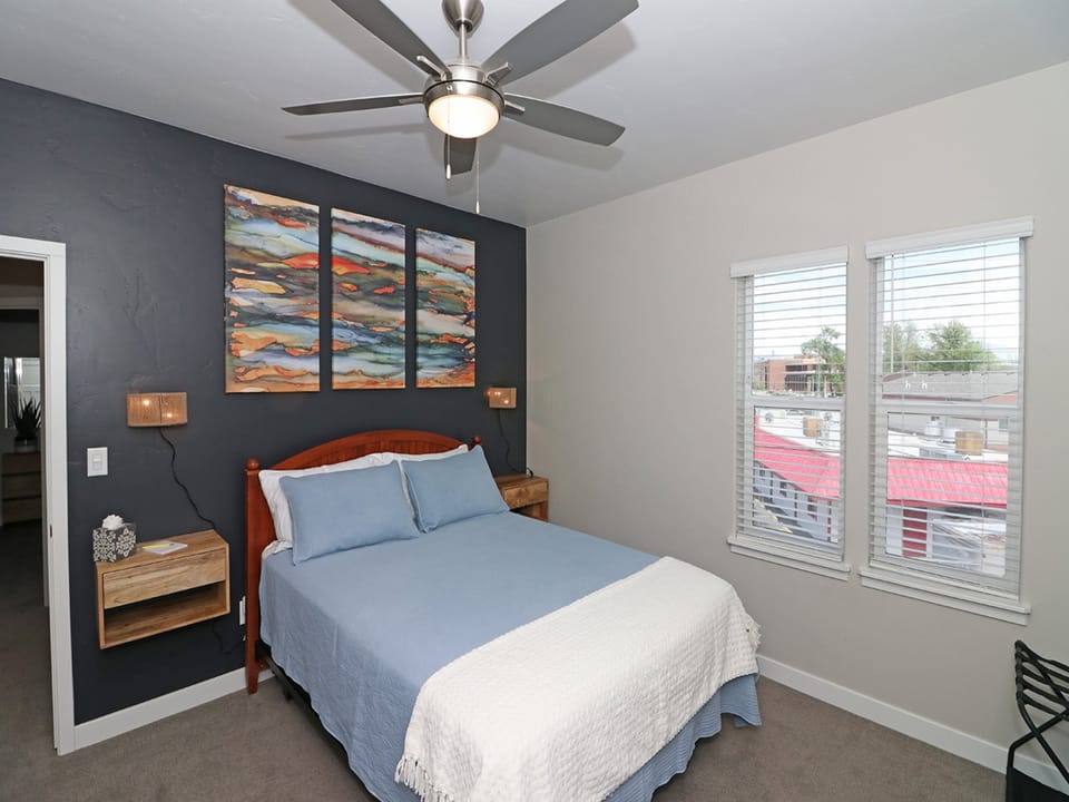 Master bedroom with queen bed and private balcony