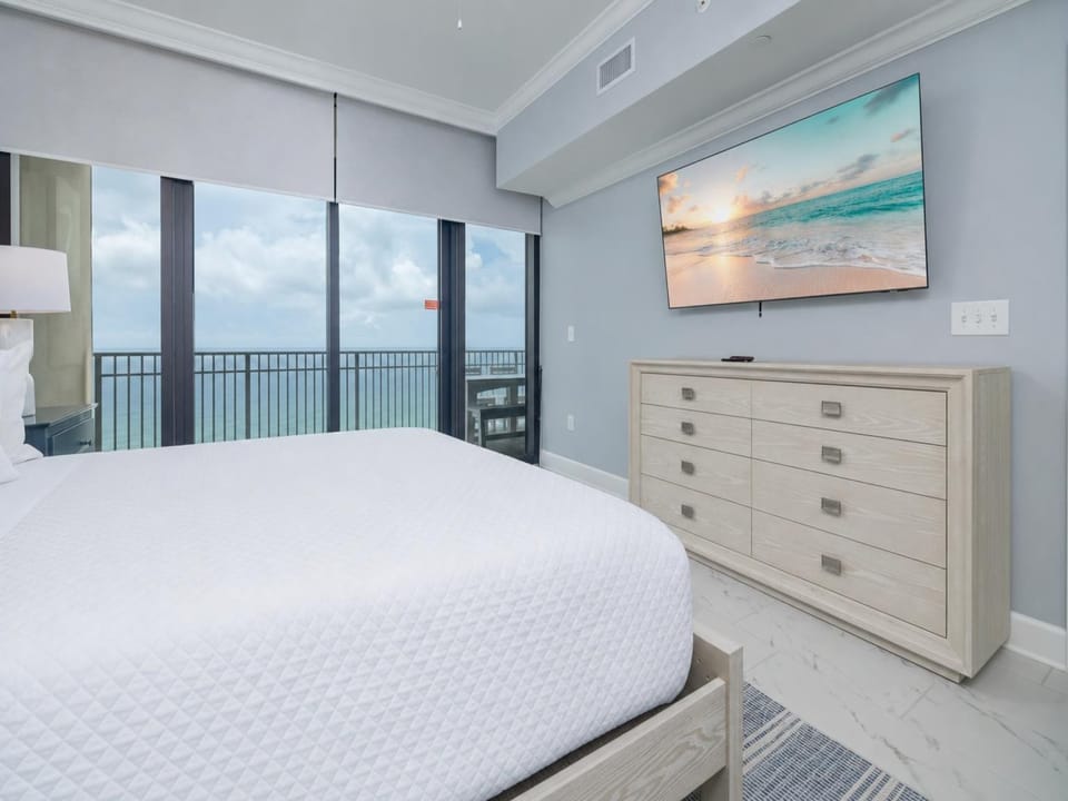 Unwind in this inviting master bedroom with a king bed and sleep peacefully to the sound of gentle waves